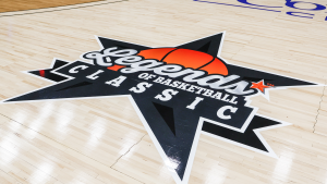 A close-up of the Legends of Basketball Classic logo on a basketball court